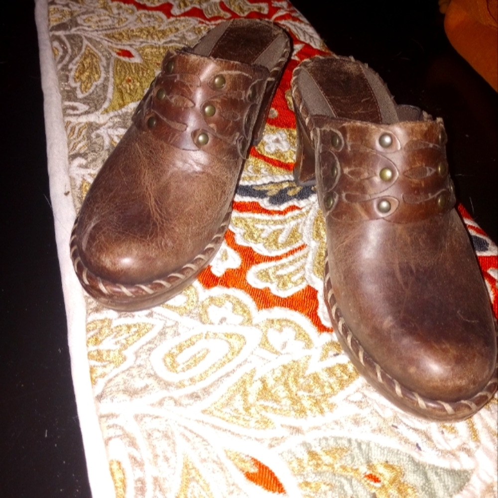 lightly worn leather clogs